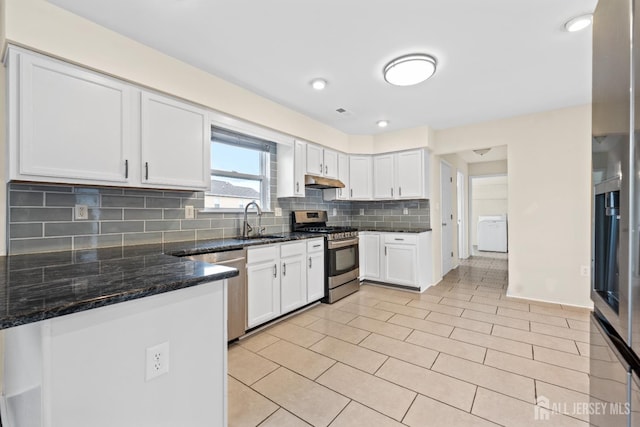 96 Lark Dr, South River, NJ 08882 - kitchen with stainless steel appliances, white cabinetry, backsplash, dark stone countertops, and light tile patterned floors