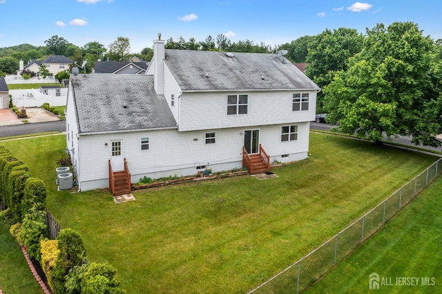 96 Lark Dr, South River, NJ 08882 - rear view of property featuring entry steps, a fenced backyard, a chimney, and a shingled roof