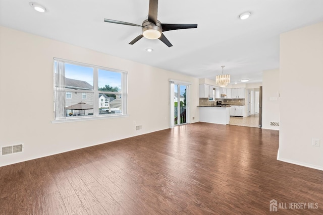 96 Lark Dr, South River, NJ 08882 - unfurnished living room with a chandelier, light wood-style floors, plenty of natural light, a ceiling fan, and recessed lighting