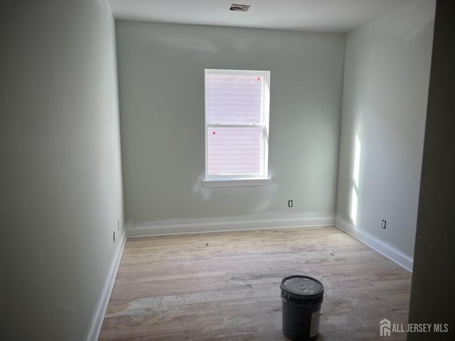 spare room with light hardwood / wood-style flooring