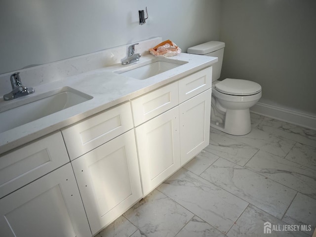 bathroom featuring toilet and vanity