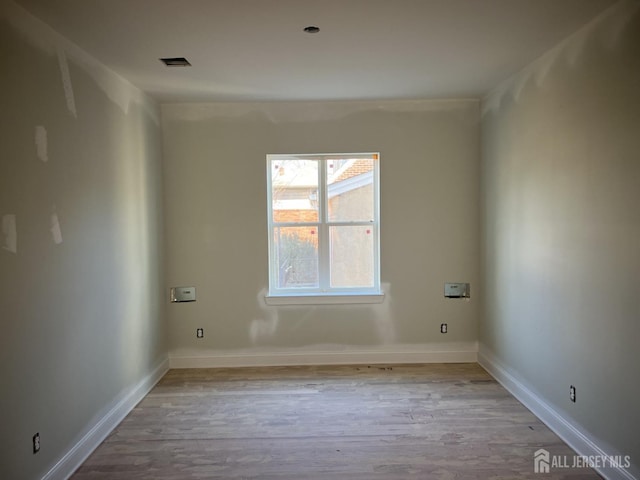 spare room with light hardwood / wood-style floors