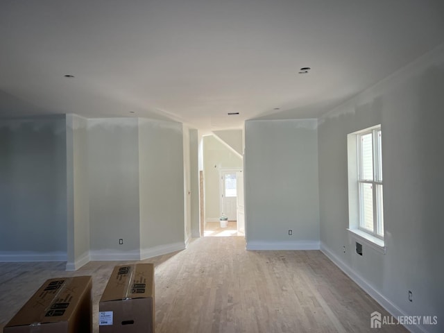 unfurnished room with light wood-type flooring