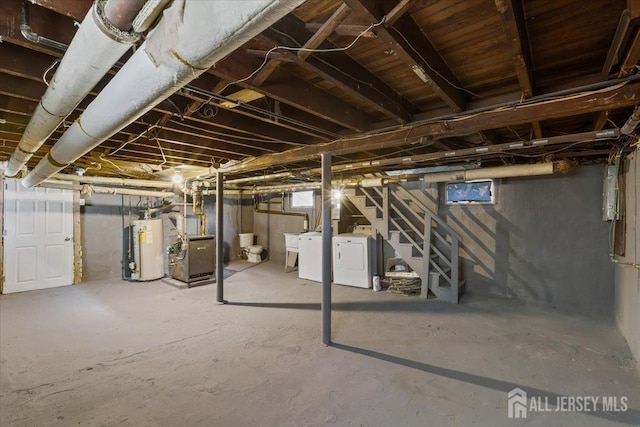 unfinished basement with stairs, independent washer and dryer, heating unit, and gas water heater