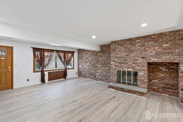 13 Lillian Ter, Woodbridge Proper, NJ 07095 - unfurnished living room featuring baseboards, wood finished floors, a fireplace, brick wall, and recessed lighting