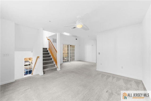 unfurnished living room with stairs, ceiling fan, carpet flooring, and visible vents