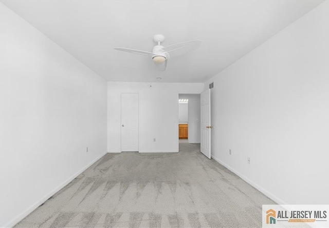 unfurnished bedroom with a ceiling fan, carpet, visible vents, and baseboards