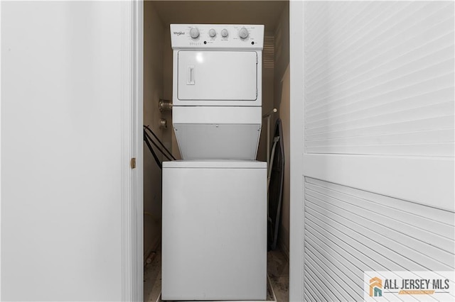 laundry room with stacked washer and dryer and laundry area