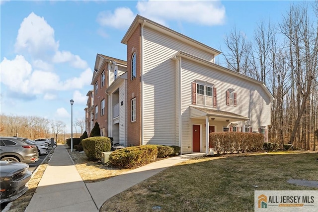 1177 Morning Glory Dr Unit 1177, Monroe, NJ 08831 - view of property exterior with a yard and uncovered parking