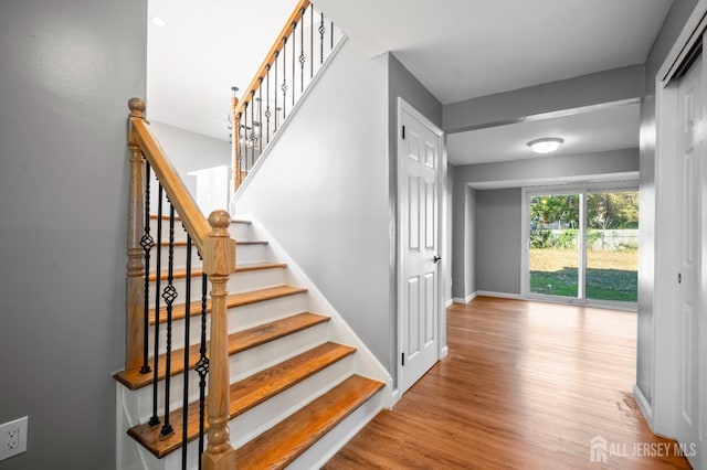 staircase featuring wood-type flooring