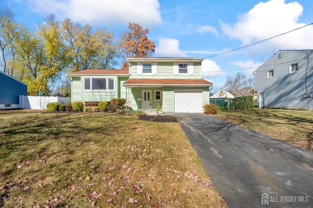 split level home with a front lawn and a garage