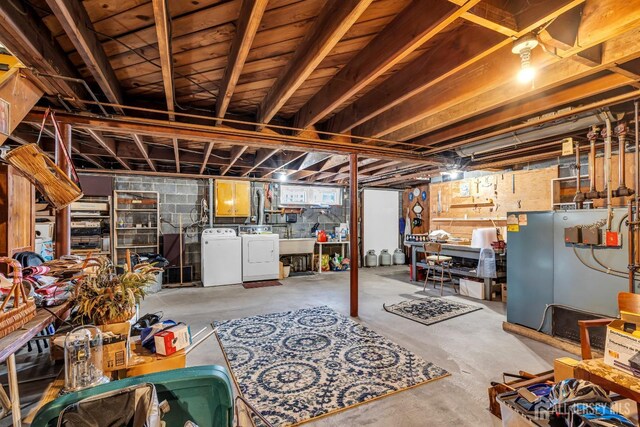 basement featuring washer and clothes dryer and sink