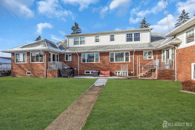 72-74 Sabo St, Carteret, NJ 07008 - back of property with a yard, brick siding, and roof with shingles