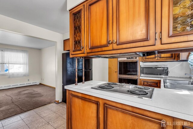 72-74 Sabo St, Carteret, NJ 07008 - kitchen with stainless steel appliances, light carpet, brown cabinetry, light countertops, and baseboard heating