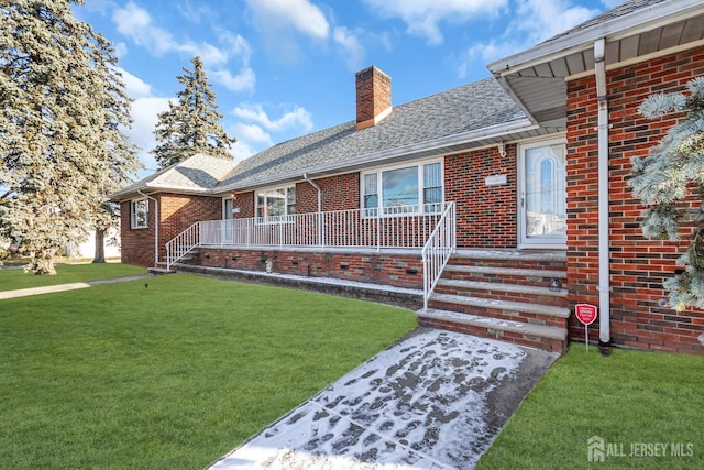 72-74 Sabo St, Carteret, NJ 07008 - ranch-style house with a chimney, brick siding, a front yard, and roof with shingles