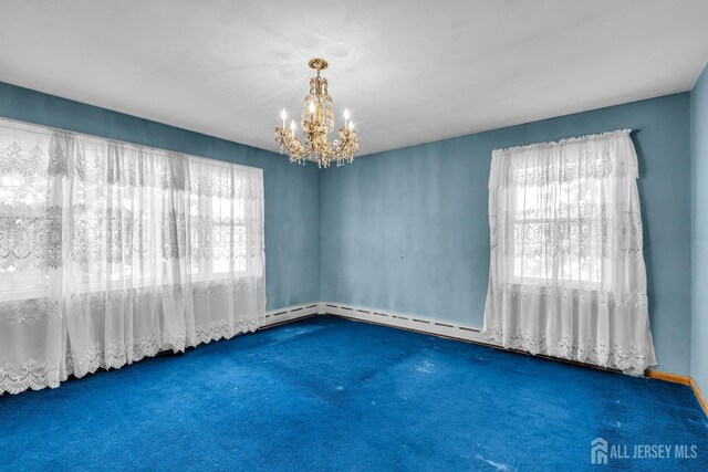 carpeted spare room with an inviting chandelier