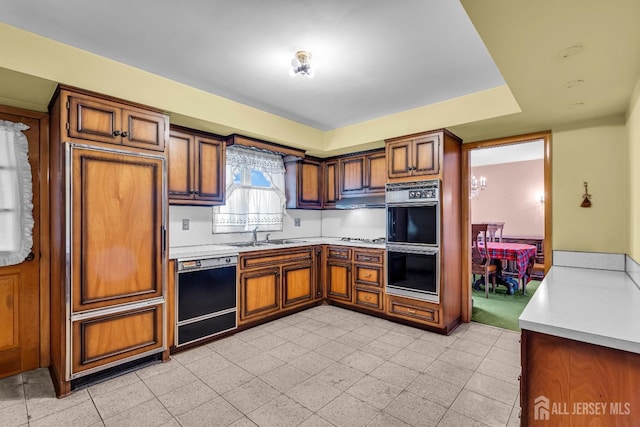 72-74 Sabo St, Carteret, NJ 07008 - kitchen featuring black dishwasher, double oven, a sink, light countertops, and brown cabinets