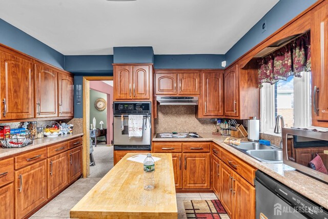 kitchen with butcher block counters, dishwasher, tasteful backsplash, white gas cooktop, and oven