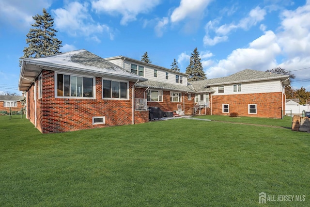 72-74 Sabo St, Carteret, NJ 07008 - rear view of house featuring brick siding and a lawn