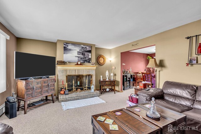 living room with carpet and a brick fireplace