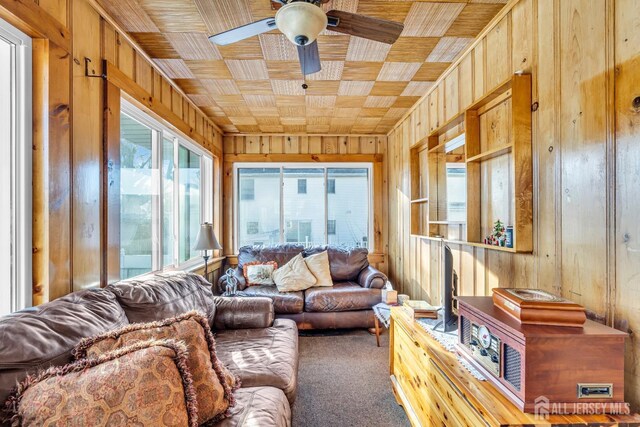 sunroom featuring ceiling fan and wooden ceiling