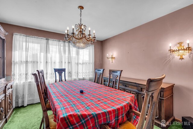 carpeted dining area with a notable chandelier