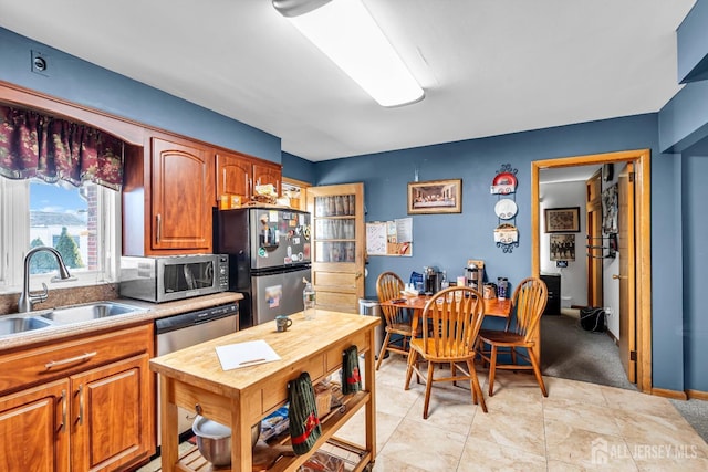 72-74 Sabo St, Carteret, NJ 07008 - kitchen with appliances with stainless steel finishes, a sink, brown cabinets, butcher block counters, and light colored carpet