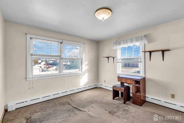 carpeted empty room with a healthy amount of sunlight and baseboard heating