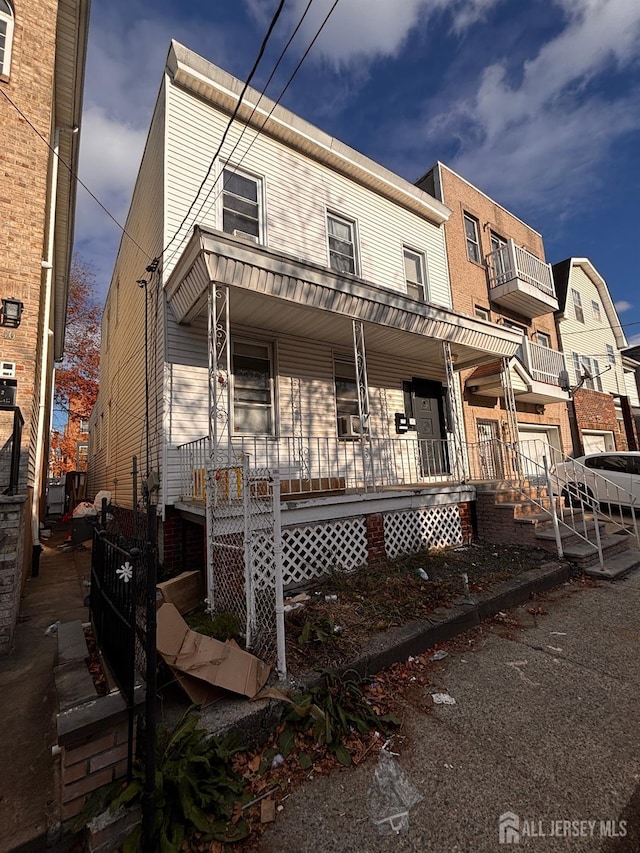 townhome / multi-family property with a porch