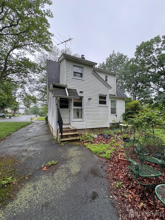 133 Harding Ave, Edison, NJ 08820 - view of front of property featuring a shingled roof, a chimney, and entry steps