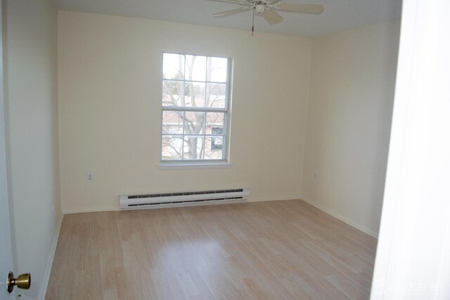 spare room with ceiling fan, a baseboard radiator, and light hardwood / wood-style flooring