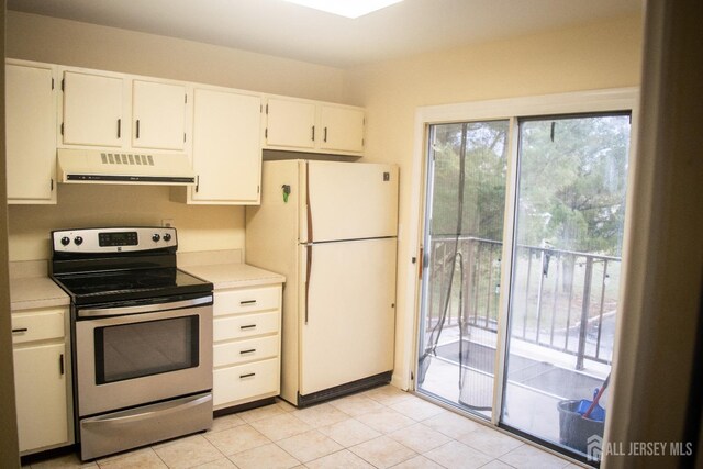 kitchen with white fridge, white cabinetry, electric stove, and light tile patterned floors