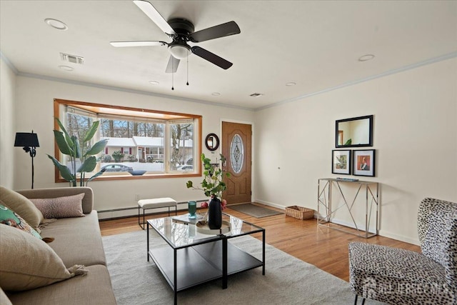 living room with crown molding, a baseboard radiator, light hardwood / wood-style floors, and ceiling fan