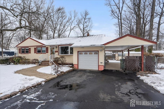 ranch-style house featuring an attached garage, fence, a chimney, and aphalt driveway
