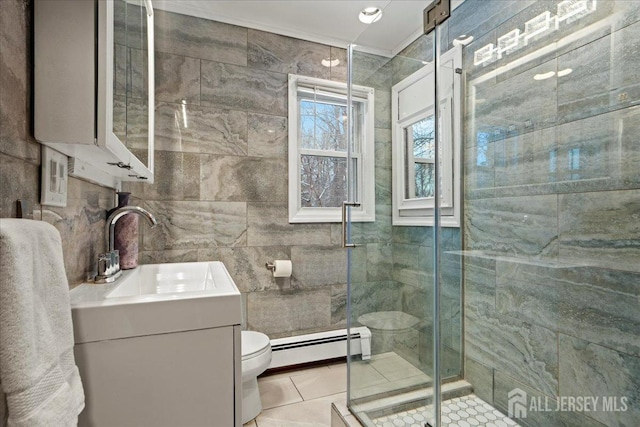 bathroom featuring tile patterned flooring, toilet, tile walls, a baseboard heating unit, and a stall shower