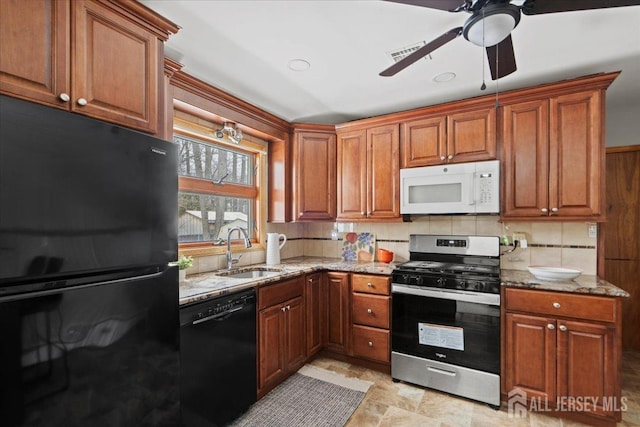 kitchen featuring sink, ceiling fan, tasteful backsplash, black appliances, and light stone countertops