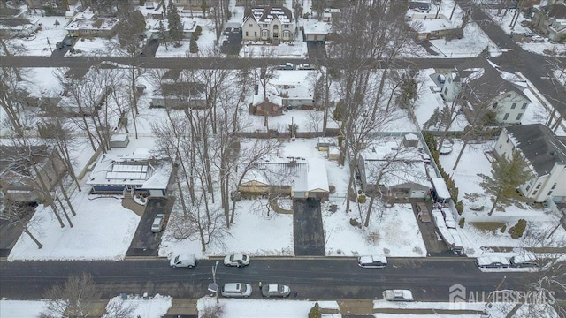 snowy aerial view featuring a residential view