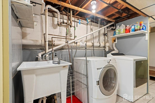 laundry room with washing machine and dryer and sink