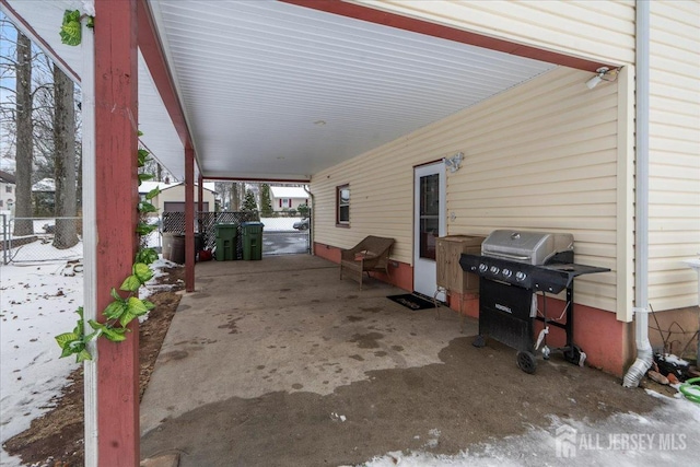 view of patio / terrace with an attached carport, fence, and a grill