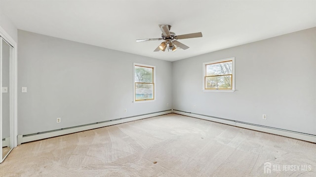 carpeted empty room with ceiling fan, a healthy amount of sunlight, and baseboard heating