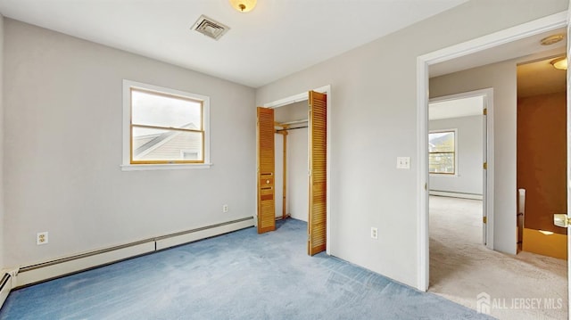 unfurnished bedroom featuring carpet, a baseboard radiator, a baseboard heating unit, visible vents, and a closet