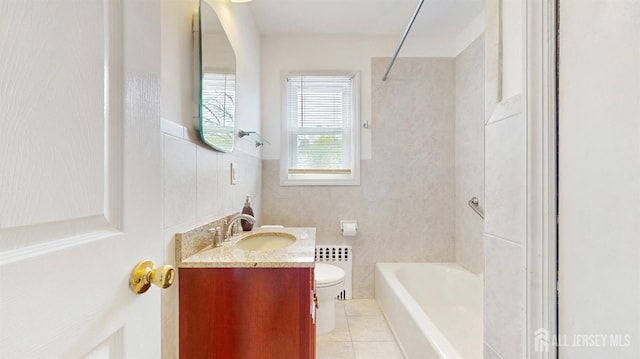 bathroom with vanity, toilet, tile patterned flooring, and a wainscoted wall