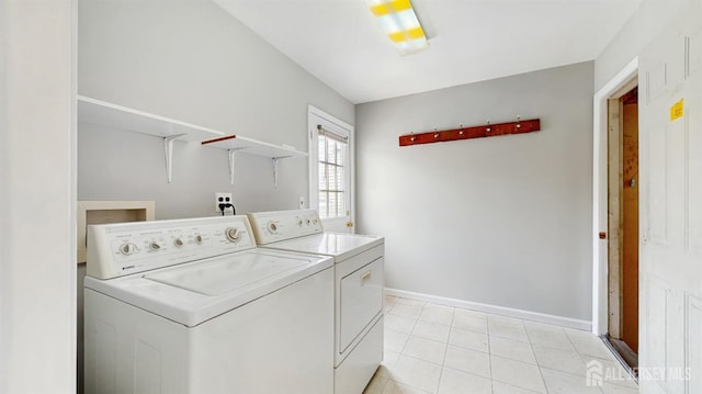 laundry room featuring laundry area, baseboards, light tile patterned floors, and washing machine and clothes dryer