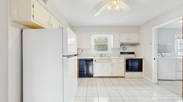 kitchen with washing machine and clothes dryer, a sink, electric stove, black dishwasher, and freestanding refrigerator