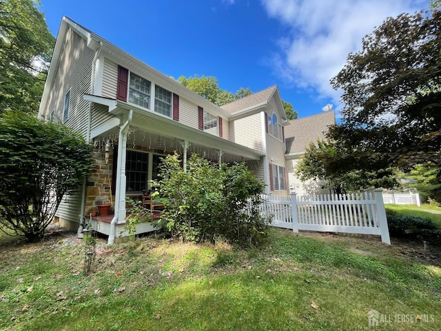 view of side of home with a yard