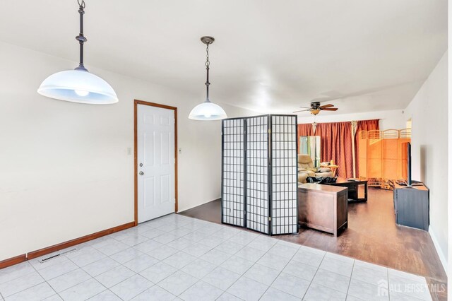 kitchen with ceiling fan, light tile patterned floors, and hanging light fixtures