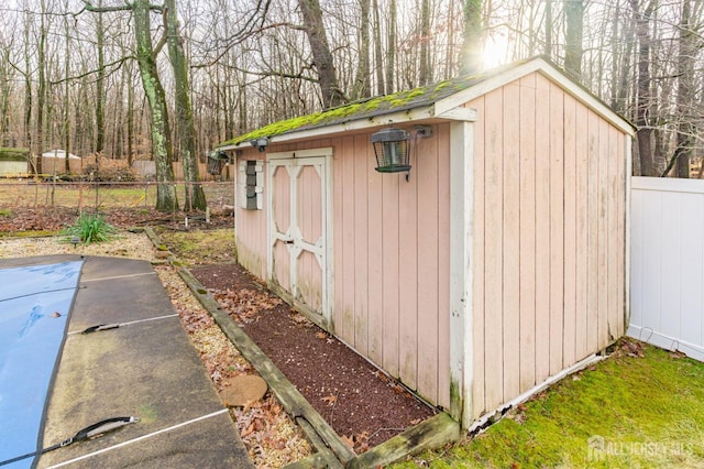 view of shed featuring fence