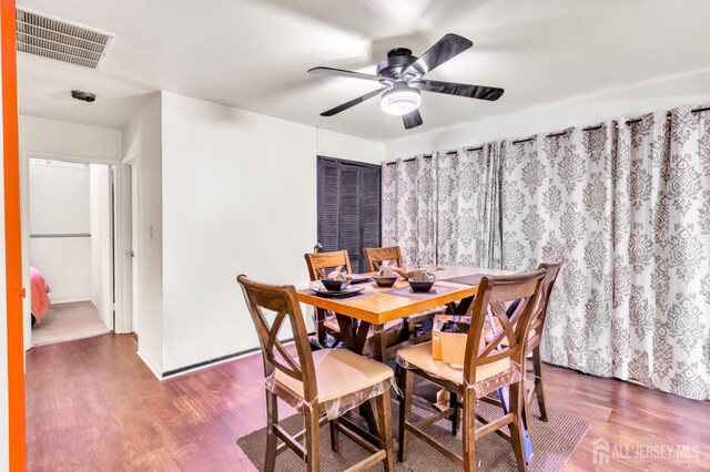 dining room with ceiling fan and hardwood / wood-style flooring