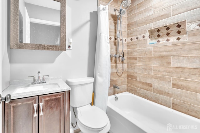 bathroom featuring toilet, shower / tub combo with curtain, and vanity