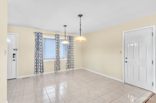 unfurnished dining area featuring visible vents, baseboards, and light tile patterned floors